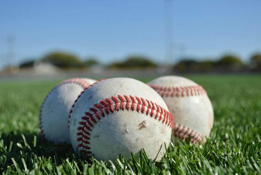 Three baseballs sit in a field of turfgrass at Camp Nubability's annual kids camp for limb different children. This image was taken by one of the camp coaches, Caitlin Conner.