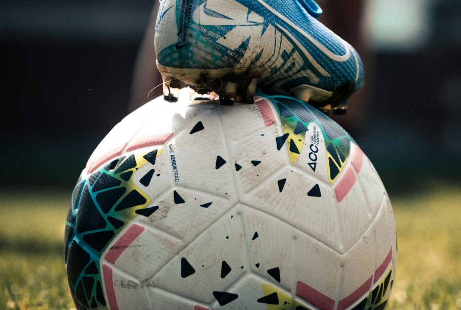 white and blue soccer ball on green grass field